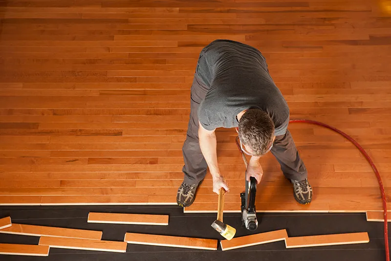 Worker installing hardwood flooring | Jordans Flooring
